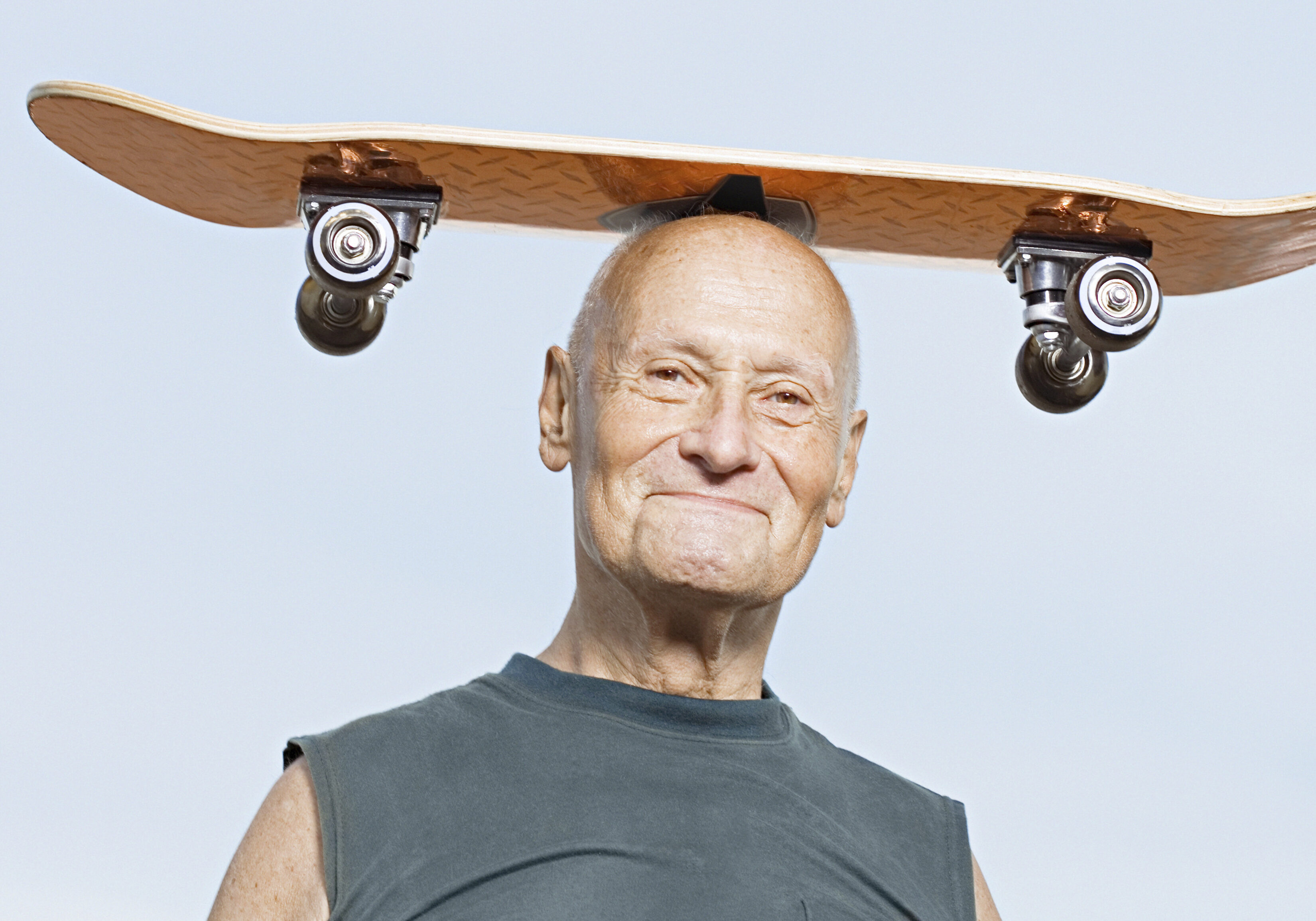 Man with skateboard on his head